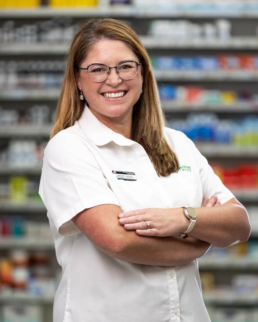 Karlien Venter, the responsible pharmacist, standing in front of the dispensary shelves