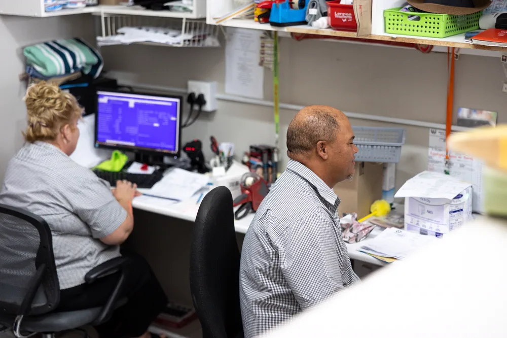Two members of the Albertyn team working at the computer in the back office